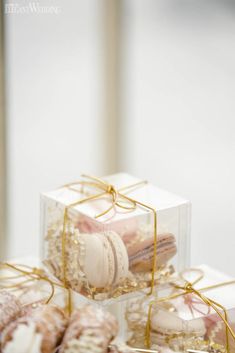 three boxes filled with different types of pastries