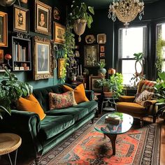 a living room filled with lots of green furniture and pictures on the wall above it