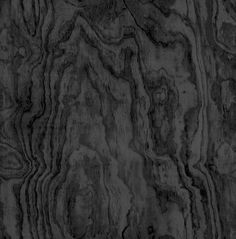 an abstract black and white photo of wood grained in to form a wavy pattern