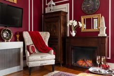 a living room filled with furniture and a fire place in front of a tv mounted on a wall