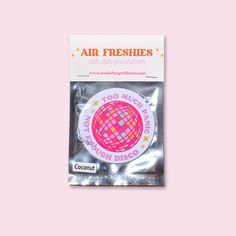 an air freshener sticker on a pink background