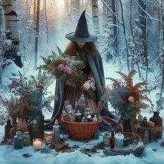 a woman in a witch costume surrounded by candles and flowers sitting on the snow covered ground