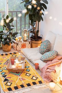 a living room filled with lots of furniture and decor on top of a wooden floor