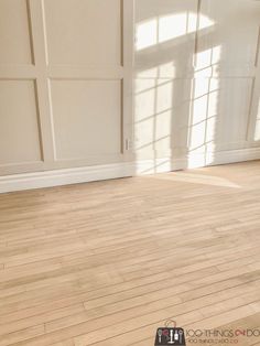 an empty room with hard wood floors and white walls