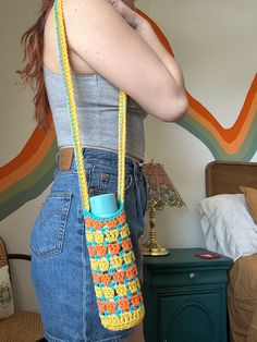 a woman is holding a crocheted purse