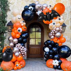 an entrance decorated with halloween balloons and pumpkins