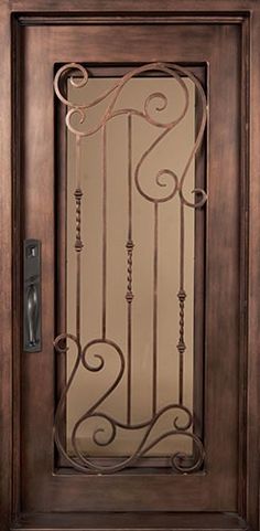 a wooden door with wrought iron designs on it