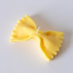 a yellow piece of food on a white surface