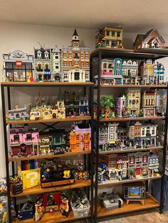 several shelves filled with various types of toy houses