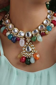 This navrattan necklace set with its pop of colors and quirky shapes is a sublime piece. The subtelty of the polki with hints of muted golden tones creates the perfect balance to create a winning look. Necklace Closure - Adjustable Dori Earrings Closure - Push Back Style Tip - This multicolored piece of art is perfect for gracing traditional funtions in full pomp and show. Navrattan itself being the traditional epitome of prosperity, wealth and status. What could be better than Handcrafted in Ja Multicolor Temple Jewelry Necklace As Gift, Multicolor Temple Jewelry Necklace For Gift, Multicolor Temple Jewelry Necklaces For Gift, Celebration Multicolor Temple Jewelry Necklaces, Multicolor Necklaces For Festivals And Celebrations, Unique Multicolor Festive Jewelry, Multicolor Handmade Kundan Necklace For Party, Handmade Multicolor Kundan Necklace For Party, Multicolor Necklaces For Festive Gifts