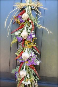 a bunch of flowers hanging from the side of a door