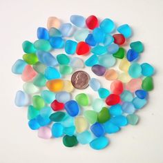 a penny sitting on top of a pile of gummy bears next to jelly beans