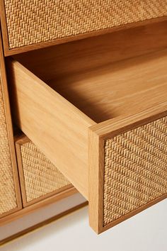 a close up of a wooden drawer with wicker drawers