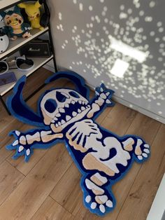 a blue rug with a skeleton on it in front of a book shelf filled with toys