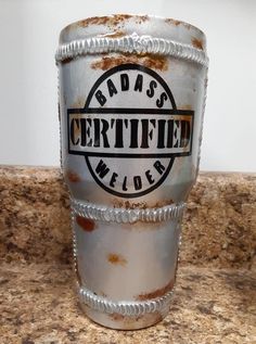 a metal cup sitting on top of a counter