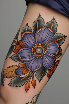 a woman's thigh with flowers and leaves on her leg, showing the tattoo design