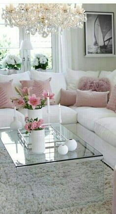 a living room with pink couches and white furnishing