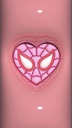 a pink heart shaped object with spiderman's eyes