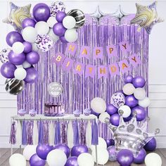 a purple and white birthday party with balloons