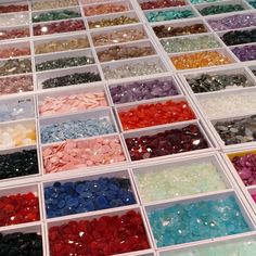 there are many different colors of beads in the bins