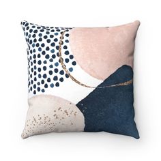 a pillow with an abstract design on the front and back of it, featuring dots