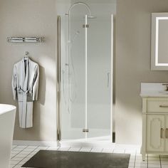 a white bathroom with a walk in shower next to a bathtub and sink area