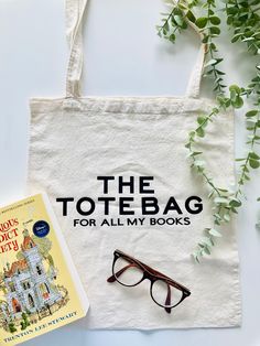 the tote bag for all my books is next to a pair of glasses