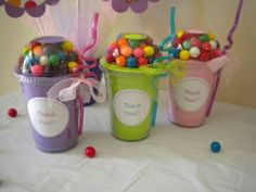 some candy and candies are in buckets with mickey mouse ears on them,