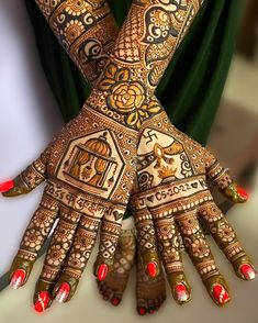 two hands with henna designs on them