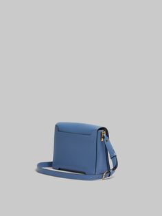 Trunkaroo medium rectangular shoulder bag crafted from calfskin leather. Front flap with magnetic closure, featuring engraved Marni lettering and oversized stud details. Contoured base on the front and back. One compartment with inside pocket. Lined in nappa leather. Detachable and adjustable buckled shoulder strap: can also be worn as a clutch. Classic Blue Calf Leather Shoulder Bag, Blue Leather Flap Bag With Magnetic Closure, Blue Leather Flap Bag, Designer Office Saddle Bag, Rectangular, Designer Rectangular Saddle Bag For Office, Rectangular Saddle Bag With Magnetic Closure, Blue Luxury Leather Saddle Bag, Luxury Blue Leather Saddle Bag, Luxury Rectangular Saddle Bag With Magnetic Closure