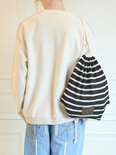 It is a drawstring bag made of textured knit fabric. The drawstring length is adjustable to fit different body shapes.- Logo label- Logo patch- Stripe pattern- Unisex item Casual Drawstring Shoulder Bag For Travel, Casual Travel Shoulder Bag With Drawstring, Casual Bucket Bag, Casual Knitted Pouch Bag, Casual Knitted Shoulder Bag, Black Drawstring Bags For Daily Use, Casual Pouch Drawstring Bag For Travel, Casual Drawstring Pouch Bag For Travel, Casual Black Pouch Bucket Bag