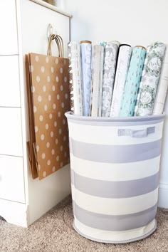 a white and gray striped bin with papers in it