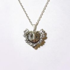 An antique silver owl charm placed on a silver plated heart locket. The locket is etched with beautiful patterns and opens easily for a spot to put in your dearest memories. It hangs on a 24 inch silver tone chain.It is packaged in a lovely little silhouette box, set on a soft piece of white cotton.••••••••••••••••••••••••••••••••••••••• ♥ • ♥ • ♥ • ♥ • ♥ • ♥ • ♥ • ♥ •••••••••••••••••••••••••••••••••••••••••© Original design by Twilight's CastleThank you for visiting!Twilight's Castle Vintage Handmade Heart Necklace Gift, Handmade Vintage Heart Necklace For Gift, Spiritual Heart Necklace As A Valentine's Day Gift, Symbolic Antique Silver Jewelry Gift, Antique Silver Symbolic Jewelry For Gift, Nickel-free Symbolic Jewelry For Valentine's Day, Symbolic Nickel-free Jewelry For Valentine's Day, Vintage Nickel-free Heart Necklace As Gift, Silver Symbolic Necklace For Valentine's Day