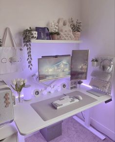 a white desk topped with a computer monitor and keyboard