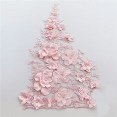 pink flowers are arranged in the shape of a christmas tree