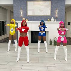 four women dressed up in costumes posing for the camera