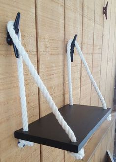 there is a shelf with two ropes attached to it