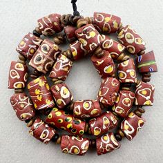 "A strand of mixed brown and white Venetian Beads traded to Africa in the late 1800's or early 1900's. In overall good condition with some chips on a few.  27 beads 19\" strand with wood spacers 10 to 11mm diameter  2mm hole on average" Traditional Brown Beaded Necklace With Multicolored Beads, Brown Polished Beads For Jewelry Making, Traditional Brown Beaded Necklace With Colorful Beads, Brown Beaded Necklace With Colorful Oval Beads, Vintage Brown Beaded Necklaces With Colorful Beads, Vintage Style Wooden Beads For Jewelry Making, Artisan Brown Beaded Necklaces With Oval Beads, Artisan Brown Beaded Necklace With Oval Beads, Vintage Brown Beads For Jewelry Making