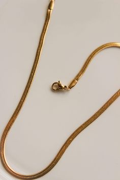 PRODUCT DESCRIPTION You'll want to keep our Snake Chain Necklace on high rotation this season! This sleek and chic necklace is such a simple but must-have staple as it's the perfect base for layering other necklaces and it can easily elevate any outfit. Timeless Gold Necklace Water Resistant 18k Gold-plated titanium steel 30cm in length plus 10cm adjustable chain 3mm in width Read our full Jewellery Care Guide here Read our Sizing Guide here Minimalist Snake Chain Layered Necklace, Gold Snake Chain Layered Necklace, Minimalist Double Chain Herringbone Necklace For Everyday, Trendy Everyday Delicate Snake Chain Necklace, Everyday Trendy Delicate Snake Chain Necklace, Minimalist Snake Chain Clavicle Choker, Minimalist Metal Snake Chain Choker, Minimalist Double Chain Herringbone Necklace, Minimalist Layered Necklace With Clavicle Chain