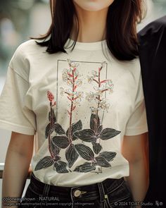 Indulge your passion for orchids with our exquisite Jewel Orchid Blockprint t-shirt design, crafted to capture the delicate beauty of these rare blooms in vibrant detail. Perfect for plant enthusiasts and nature lovers alike, this shirt blends artistic elegance with botanical charm, making it a must-have addition to your wardrobe. Embrace the allure of orchids wherever you go and showcase your love for these stunning plants with every wear. FABRIC CONTENT:  - Fabric content varies based on color Botanical Plants Print Relaxed Fit T-shirt, Botanical Screen Print Short Sleeve T-shirt, Botanical Screen Print Crew Neck T-shirt, White Botanical T-shirt With Floral Print, White Botanical Floral Print T-shirt, White T-shirt With Botanical Print, White Floral Print T-shirt, Botanical Flower Graphic Print T-shirt, Botanical Style Flower Graphic T-shirt