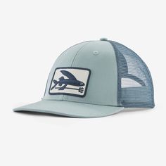 a blue trucker hat with an airplane patch on the front and white mesh back