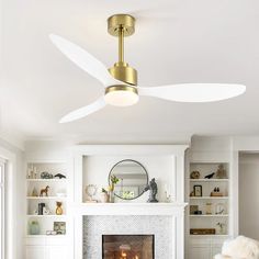 a living room with a fire place and a ceiling fan in the middle of it