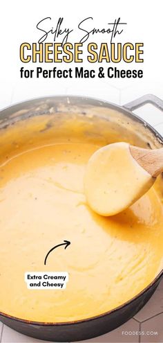 cheese sauce for perfect mac and cheese recipe in a skillet with wooden spoons