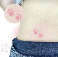 a woman's stomach with small pink paw prints on the side of her belly