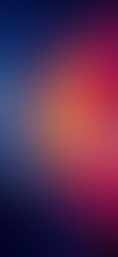 a blurry image of red, blue and pink colors on a wallpaper background