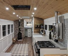 the interior of an rv with wood paneling on the walls and ceiling is clean