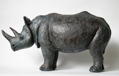 a statue of a rhinoceros is shown against a white background