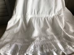 "French Fine Lace Petticoat ca. Early 1900s 4291801 IW Amazing fine cotton/linen and lace petticoat from the early 1900s. Double layered with the under ruffled underskirt. Beautiful lace inserts and tiny tuck seam design with lace bottom. All hand worked. Gathered at the top with a mother of pearl button closure. Measures; 39\" length, 30\" waist, generous size for this era. Beautiful and clean condition with a few small marks and rust spots (somewhat faded), nothing too off putting. There is he Vintage Crinoline Petticoat For Spring, Spring Vintage Crinoline Petticoat, Summer Vintage Crinoline Petticoat, Victorian White Ruffled Petticoat, Victorian White Petticoat With Ruffles, White Vintage Crinoline Petticoat, Vintage Fitted Petticoat For Daywear, Victorian White Cotton Petticoat, Victorian Cotton Petticoat For Daywear