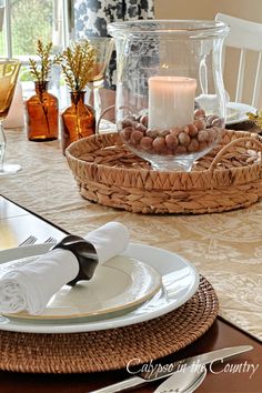 Glass hurricane with candle centerpiece and neutral place settings on fall dining table. Colors With Navy Blue, Fall Family Room, For The Home Ideas