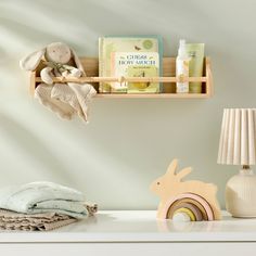 a baby's room with toys and books on the shelf, including a toy rabbit